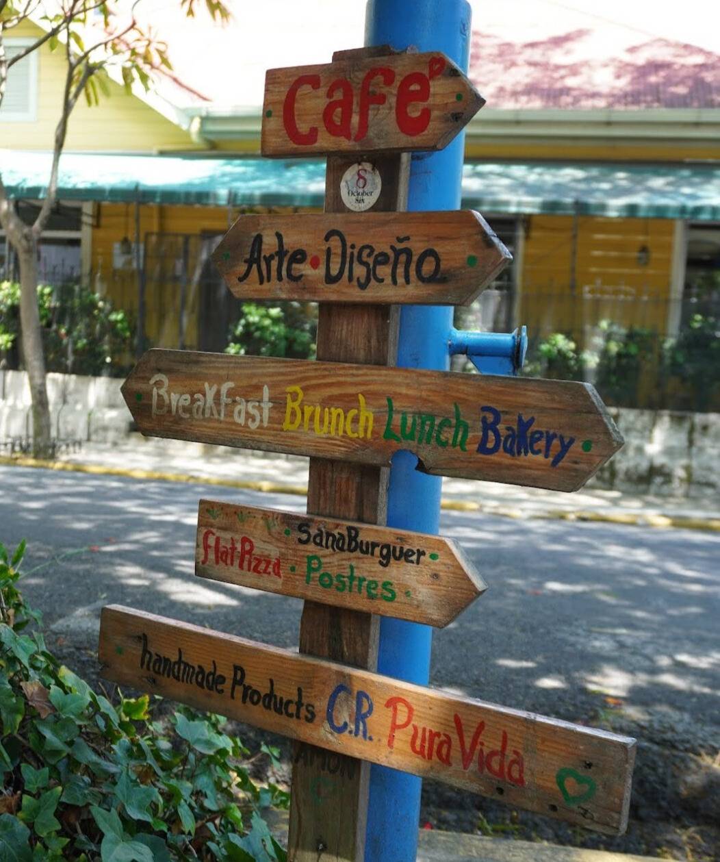Wooden sign post in English and Spanish